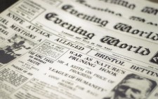 A pile of newspapers. Headlines include 'Knife Attack Alleged' and 'War As Nature's Pruning Hook'.