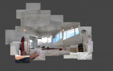 A montage of photos giving a panoramic view of Liz's view from the bed: white walls and a ceiling dotted with lights, an open door to the room, with two large high windows on the wall opposite. Liz's arm extends across the sheets.