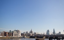 On a wide shingle foreshore, St Paul’s and the London skyline as a backdrop, Liz leans over a pile of clay, sculpting a figure.