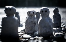 Seven figures are grouped on the foreshore, seeming to rise from the shingle, the clay and ground of similar browns and greys.