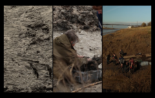 Screen is split vertically into three. Left is choppy, dark water. Centre, a figure, back to camera, leans over a plastic tub, scooping dark mud. Right, a huddle of figures digging out a mudbank, a high bank of long grass, deep gold in later afternoon sun, behind them, stretching to an arc of motorway bridge far distance.