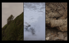 Screen is split vertically into three. Left, a windswept tree on a vegetation-covered cliff face. Centre, the fire is consumed by the tide, with gusts of steam echoing the shape and colour of seafoam. Right, the figures, encased in mesh, are dried and baked from the fire.
